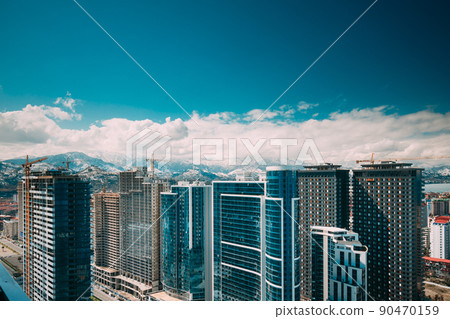 New Residential Multi-storey Houses On Blue Sky. Real Estate, Development Industry. highrise houses Elevated View Cityscape Skyline. Light Lighting. Industrial concept. Building industry 90470159