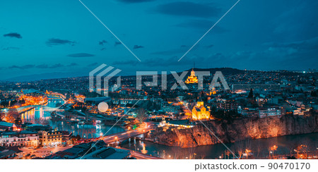 Tbilisi, Georgia. panorama night dusk evening Top View Of Famous Landmarks In spring sunset Evening dusk night. Georgian Capital Skyline Cityscape. Justice House, Bridge Of Peace, Concert Hall, 90470170