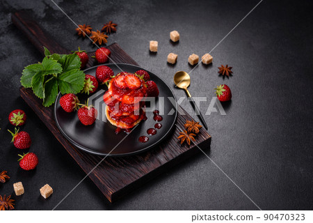 Cottage cheese pancakes with sliced strawberries and strawberry jam on a plate on a concrete background Cottage cheese pancakes with sliced strawberries and strawberry jam on a plate on a concrete background 90470323