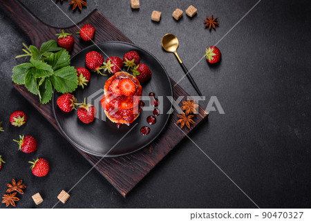 Cottage cheese pancakes with sliced strawberries and strawberry jam on a plate on a concrete background Cottage cheese pancakes with sliced strawberries and strawberry jam on a plate on a concrete background 90470327