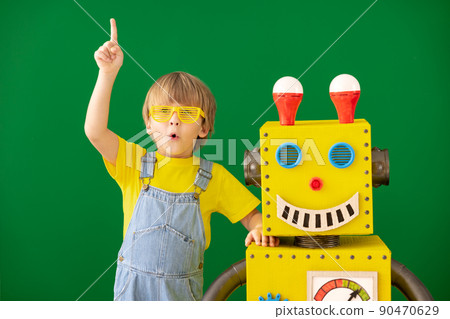 Happy child with toy robot in class 90470629