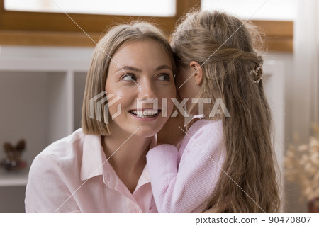 Cute little girl share secrets with young loving mother Cute little girl share secrets with young loving mother 90470807