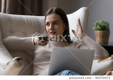 Confident young freelance employee woman talking on speaker on smartphone 90470973