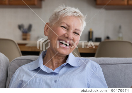 Positive old lady with stylish short hairdo laugh on joke Positive old lady with stylish short hairdo laugh on joke 90470974