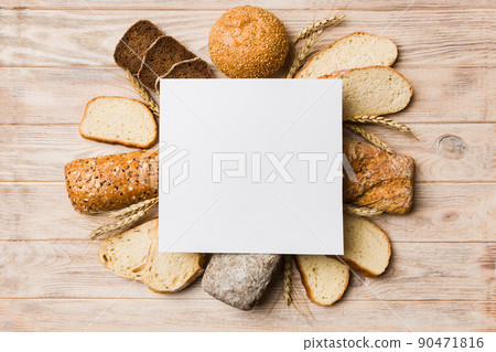 Minimalist paper blank mockup on background of Types of homemade bread. Different kinds of fresh bread as background, top view with space for your text or design 90471816