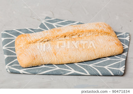 Assortment of freshly baked bread with napkin on rustic table top view. Healthy unleavened bread. French bread 90471834