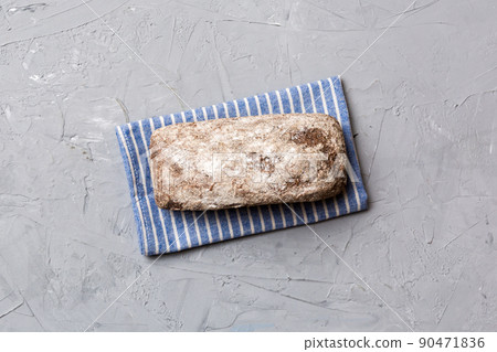 Fresh rye bread on napkin on rustic background, fresh bread top view 90471836