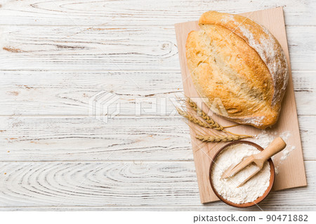 Freshly baked bread on cutting board against white wooden background. top view bread with copy space 90471882