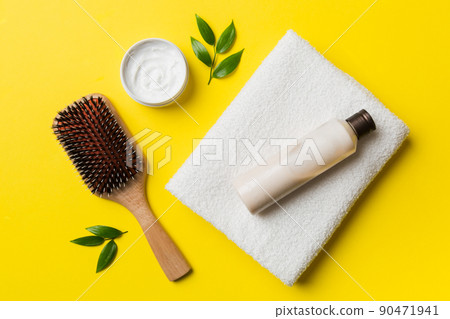 cosmetic for hair care, cream and towel on a colored background top view. flat lay cosmetic for hair care, cream and towel on a colored background top view. flat lay 90471941
