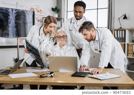Interns having meeting with senior doctor in hospital office Interns having meeting with senior doctor in hospital office 90473683