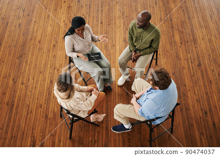 Young black woman pointing out her problem and sharing it with other people Young black woman pointing out her problem and sharing it with other people 90474037