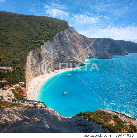 Aerial view of blue sea, rock, sandy beach at sunset in summer Aerial view of blue sea, rock, sandy beach at sunset in summer 90474039