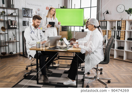 Medical experts using monitor with mock up screen on meeting 90474269