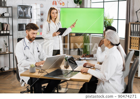 Medical experts using monitor with mock up screen on meeting 90474271