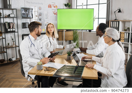 Diverse therapists using green screen monitor on briefing Diverse therapists using green screen monitor on briefing 90474273