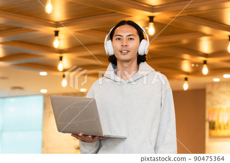 Men in headphones with a laptop 90475364