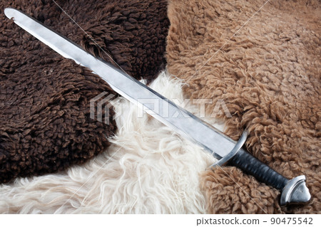 Viking Age sword on sheep fur 90475542
