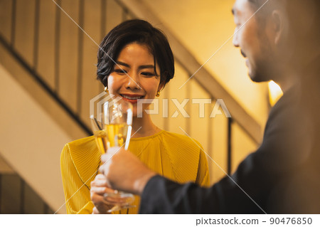 A couple drinking alcohol at the bar A couple drinking alcohol at the bar 90476850