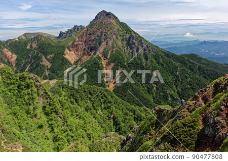 Climbers heading to Akadake and Daikiretto as seen from the Yatsugatake mountain range and Gongendake 90477808