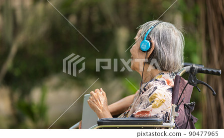 Music therapy in dementia treatment on elderly woman. 90477965