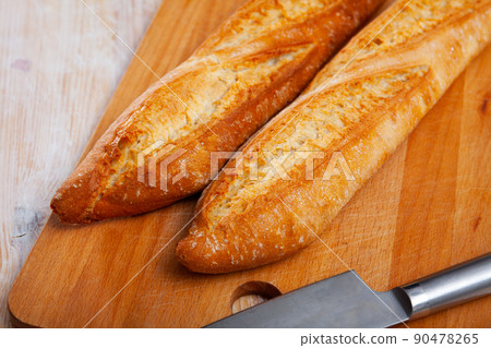 Baguette on wooden surface Baguette on wooden surface 90478265