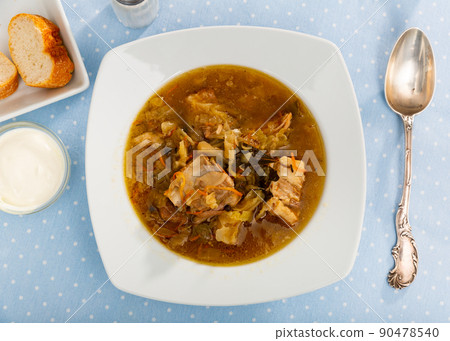 Thick cabbage soup shchi with pork cooked in mushroom broth 90478540