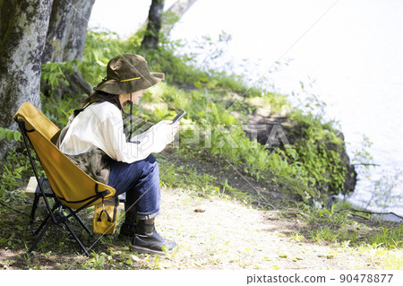 Outdoor girls chairing by the lake 90478877