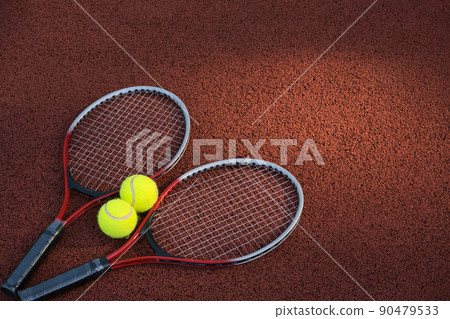 Tennis ball, racquet on hard court surface 90479533