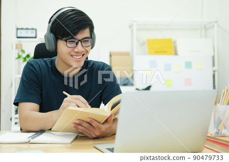 Young man study in front of the laptop computer at home Young man study in front of the laptop computer at home 90479733