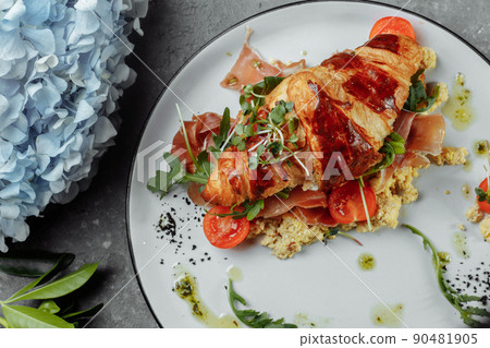 Delicious croissant sandwich with ham, cheese and scrambled eggs on plate served Delicious croissant sandwich with ham, cheese and scrambled eggs on plate served 90481905