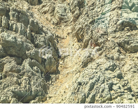 mountains in a hot country. steep descent from the mountain of sand and stone. Paths for tourists are trodden on the mountain. huge boulders among sand and dust 90482591