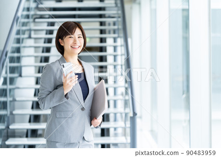 Female employee with a smartphone, female businessman Female employee with a smartphone, female businessman 90483959