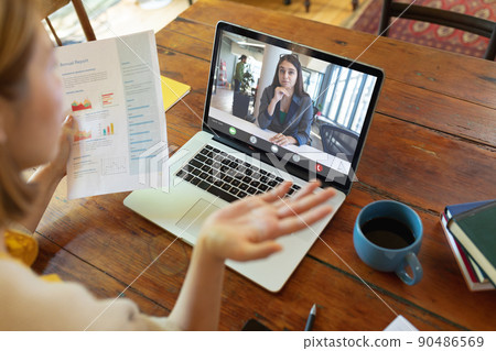 Caucasian young businesswoman gesturing during online meeting with caucasian young female colleague 90486569