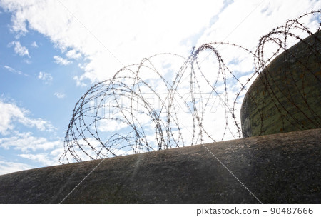 Barbed wire at an old bunker from WW2 90487666