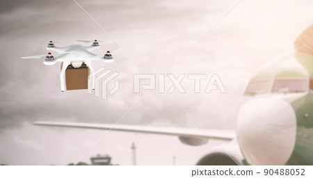 Drone carrying a box beside an airplane 90488052