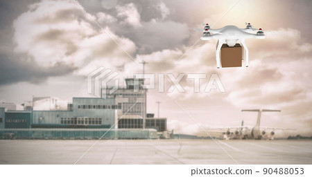 Drone carrying a box in an airport 90488053