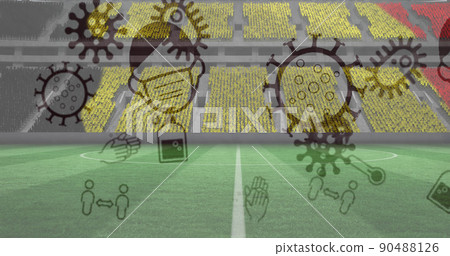 Image of covid 19 icons over belgian flag in empty spots stadium 90488126