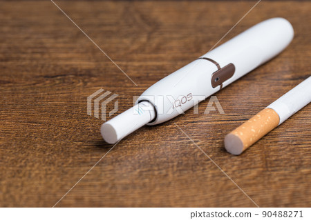 Phillip Morris International's Marlboro IQOS, electronic cigarette on on wooden background 90488271