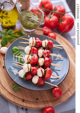 Caprese salad - Mini mozzarella cheese in glass bowl, tomato and basil Caprese salad - Mini mozzarella cheese in glass bowl, tomato and basil 90488817