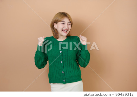 Young beautiful girl very happy and excited doing winner gesture with arms raised, smiling and screaming for success. celebration concept. Young beautiful girl very happy and excited doing winner gesture with arms raised, smiling and screaming for success. celebration concept. 90489312