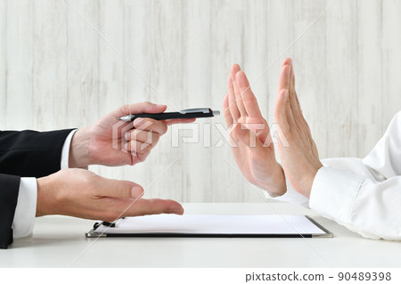 At the hands of a businessman who presses for a contract and a person who refuses it At the hands of a businessman who presses for a contract and a person who refuses it 90489398