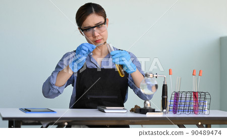 Chemist holds in hands test tube with marijuana oil for research. Herbal alternative medicine, cbd oil concept 90489474