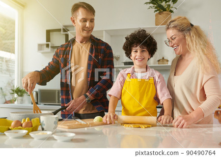 Family of Three Cooking Pasta Family of Three Cooking Pasta 90490764