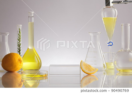 White Background  for Biological experiment presentation lemon extract and yellow water in biological test tubes. Production of cosmetics based on citrus.  90490769