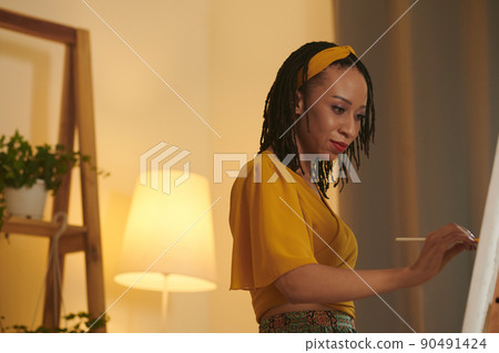 Woman Painting Picture on Easel 90491424