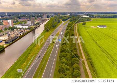 Highway in between a canal and the countryside 90491474