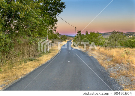 Sunrise over road in Causse Blandas Sunrise over road in Causse Blandas 90491604