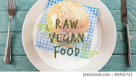 Image of raw vegan food text over fresh hamburger Image of raw vegan food text over fresh hamburger 90491721