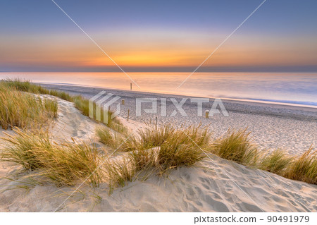 Sunset View over ocean from dune in Zeeland Sunset View over ocean from dune in Zeeland 90491979