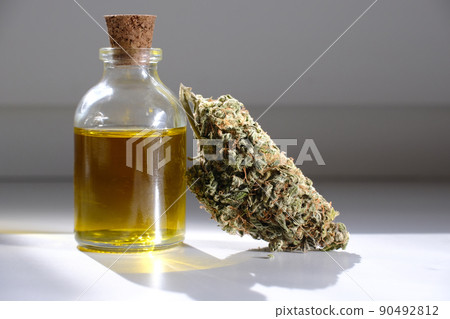 CBD oil with dry cannabis bud. Marihuana extract. 90492812